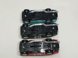 three toy cars sitting on top of each other on a table