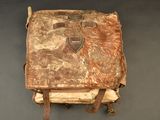 a brown bag with a brown handle on a gray surface