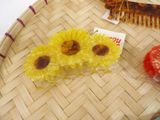 two hair combs and two flowers on a tray
