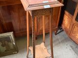 a small table with a clock on top of it in a room