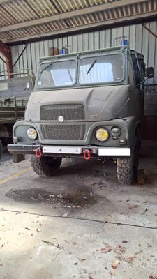 a military truck that is parked in a garage