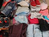 a pile of clothes and shoes on the floor