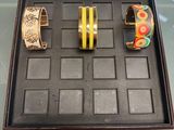 three different bracelets on display in a display case