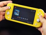 someone is holding a yellow nintendo wii game system in their hands