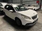 a white car parked in a garage with other cars in the background