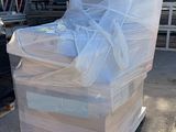 a pile of boxes sitting on top of a pallet in front of a truck