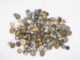 a pile of old coins on a white surface