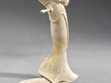 sculpture of a man with a hat on his head on a rock