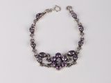 bracelet with amethorate beads and silver beads on a white background