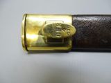a close up of a gold plated metal object on a white surface