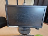 a computer monitor and a keyboard on a desk