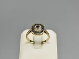 a close up of a ring on a white display stand