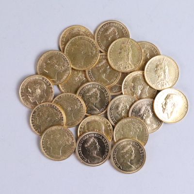 a pile of gold coins on a white surface