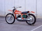 a red dirt bike parked in a parking lot