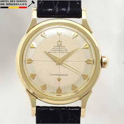 an image of a close up of a wrist watch with a gold case
