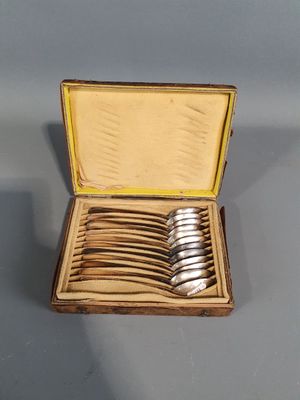 a wooden box with silverware in it on a table