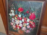 a picture of a painting of flowers in a vase on a chair