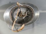 a metal helmet with a clock on it on a table