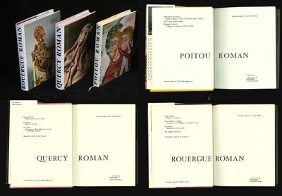 six books are lined up in a row on a black surface
