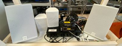 two speakers sitting on top of a table in a room