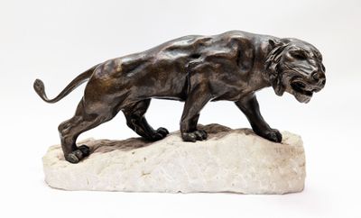 statue of a lion on a rock on a white background