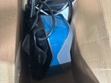 a blue and black vacuum in a cardboard box