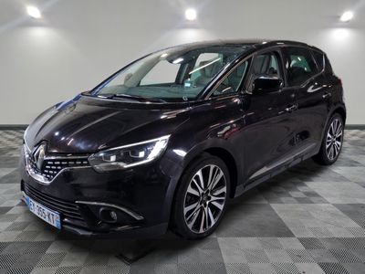 la voiture noire est garée sur un sol en damier dans le garage
