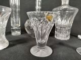 many glass vases sitting on a table next to each other