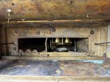 an old oven with a metal door that has a bell on it