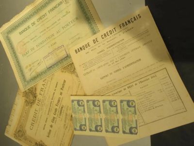several old bank cards are on display in a glass case