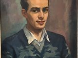 portrait of a young man in a blue sweater and white shirt