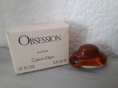 an image of a box of perfume sitting next to a box of perfume