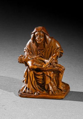 an image of a wooden statue of a woman sitting on a bench