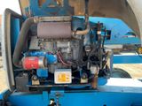 a blue truck with a large engine on the back of it