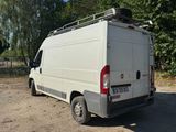 a white van that is parked in the dirt