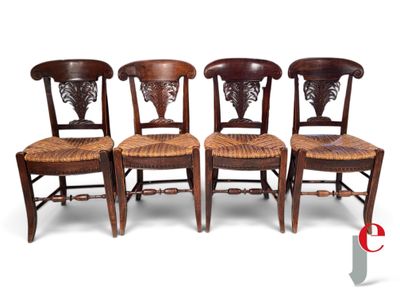 three wooden chairs with wicker seats are lined up against a white background