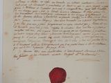 un gros plan d'une feuille de papier portant un cachet de cire