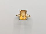 an image of a yellow sapphire ring on a white surface