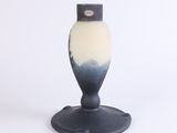 a black and white vase sitting on top of a table