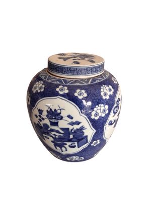 a blue and white vase with a lid on a white background