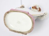 a white and pink plate with a piece of cake on it