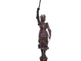 a bronze statue of a woman holding a cross and a sword
