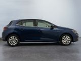 the blue car is parked on the concrete floor in the room