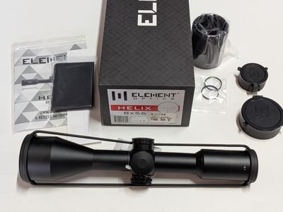 an image of a close up of a rifle scope on a table