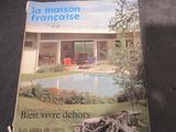 a book on the table with a picture of a house in the background