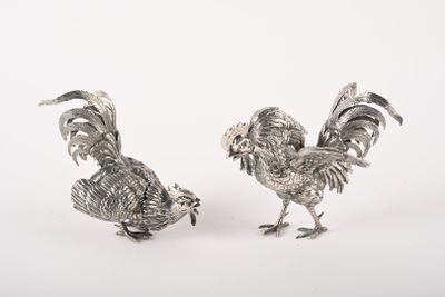 paire de figurines de coqs plaquées argent sur fond blanc