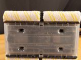 a plastic container with two sponges on top of it