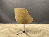 an image of a chair on a wooden floor in front of a gray wall