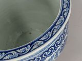 a blue and white vase sitting on a table
