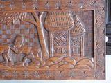 a wooden carving of a man and a dog